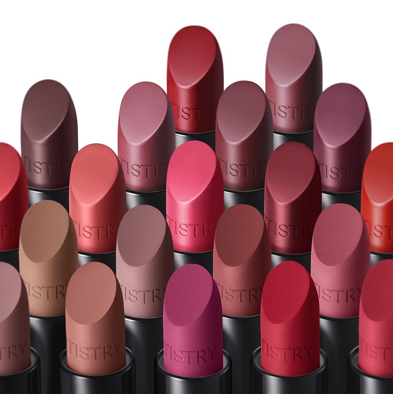 Several open tubes of Artistry Go Vibrant lipsticks are clustered together against a white background to display their shades.